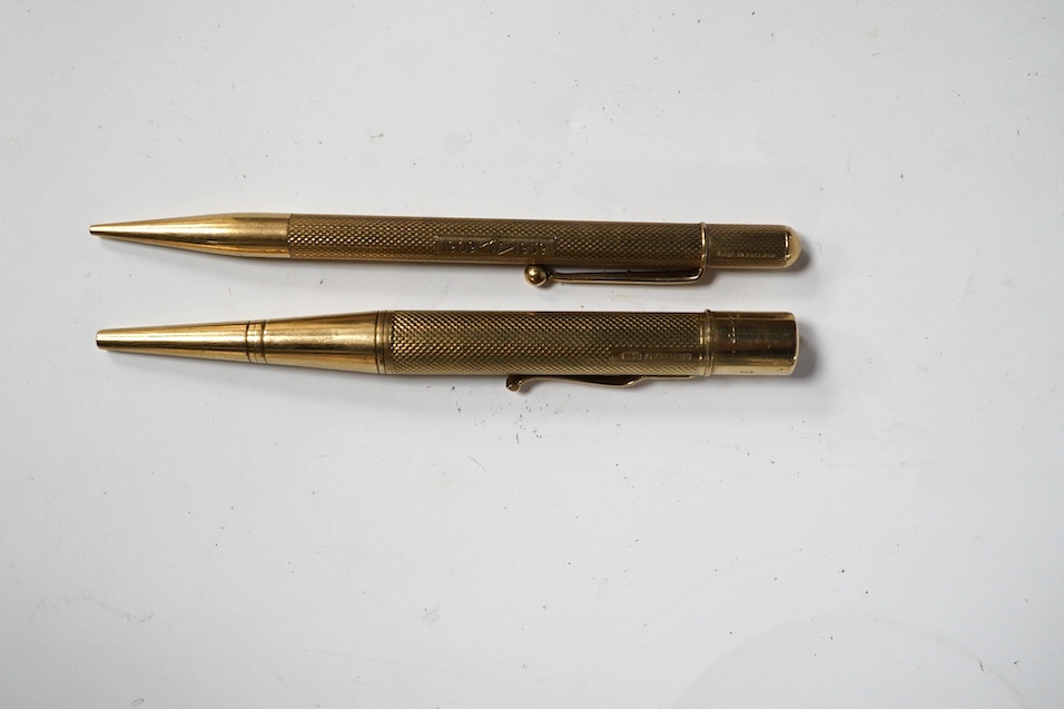 Two engine turned 9ct gold pencils, hallmarked for London, 1959 and London, 1969, both approx. 11.8cm. Condition - fair to good